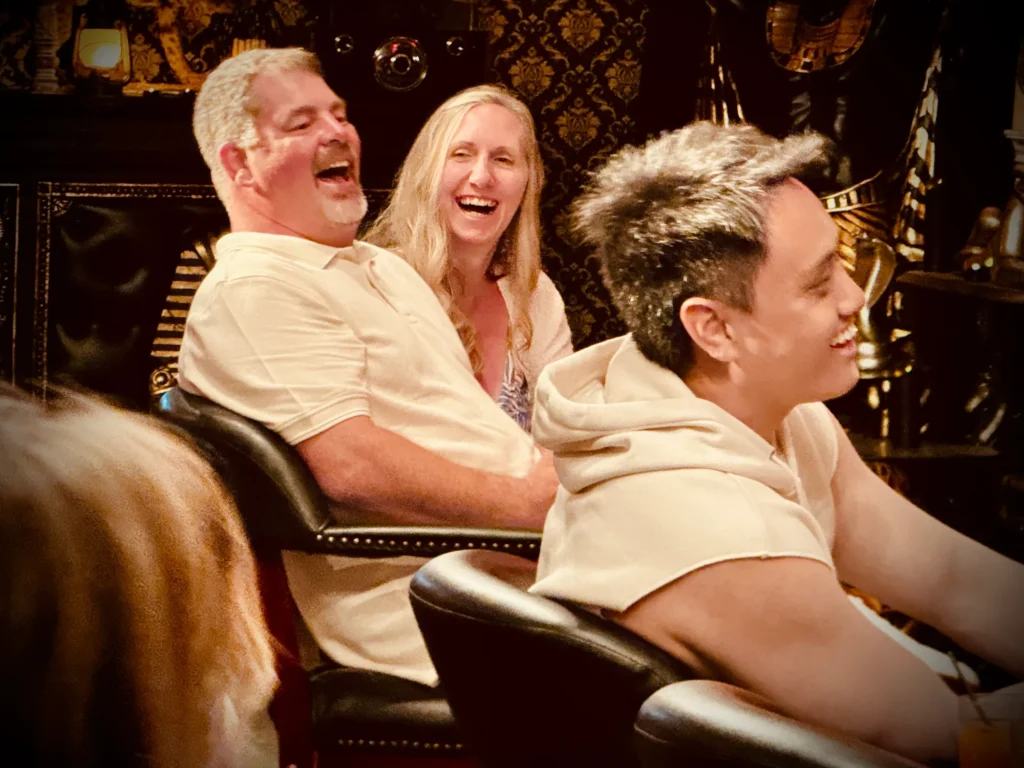 Audience members laughing during a magic show performance.