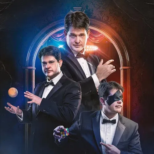 Magician in a tuxedo performing various tricks, including levitating an object, solving a Rubik's Cube, and showcasing a blindfold illusion.