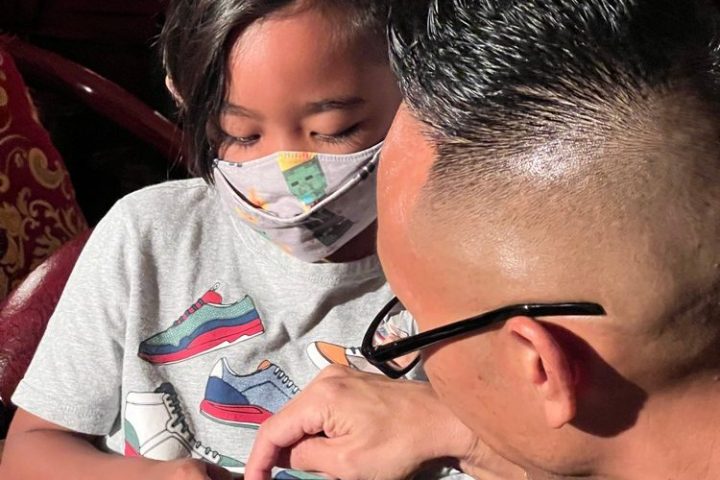 a group of people sitting in a chair talking on a cell phone