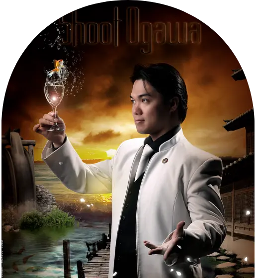 Magician in white suit holding glass with water splash, goldfish inside.